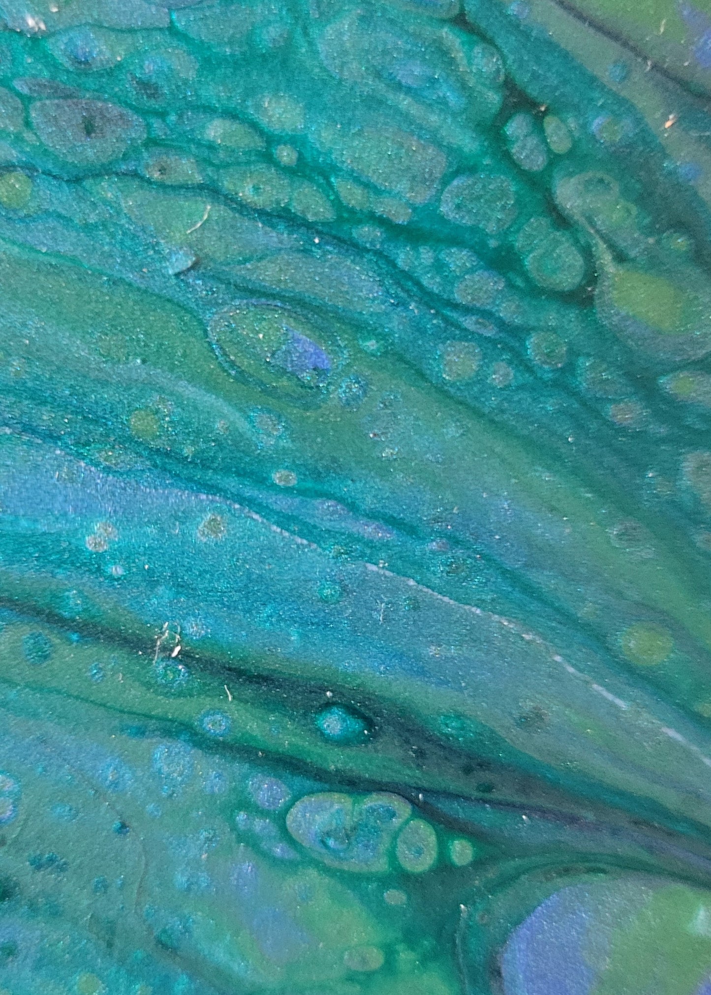 Zoomed in detail of the tile, highlighting the green and blue shades and the banding between them and around some of the color bubbles created by the fluid art density differences.