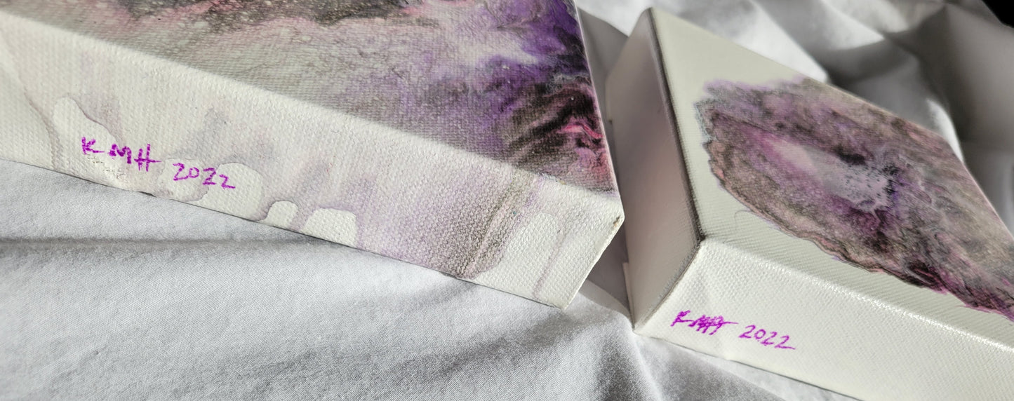 The two Carina Nebula I canvases from a side-on angle, showing the artist's initials and date completed as "KMH 2022" written in bright purple.