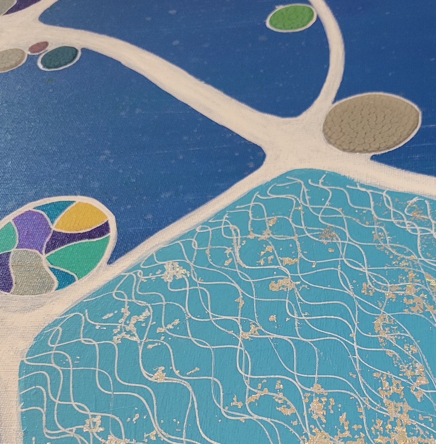 Close-up details of the distressed silver foil patches on the sky blue and squiggly white lined area of the canvas. Several alkyd circles are seen along with a multi-colored ball that highlights the purples, blues, silvers, greens, and yellows featured in the balls around the canvas.