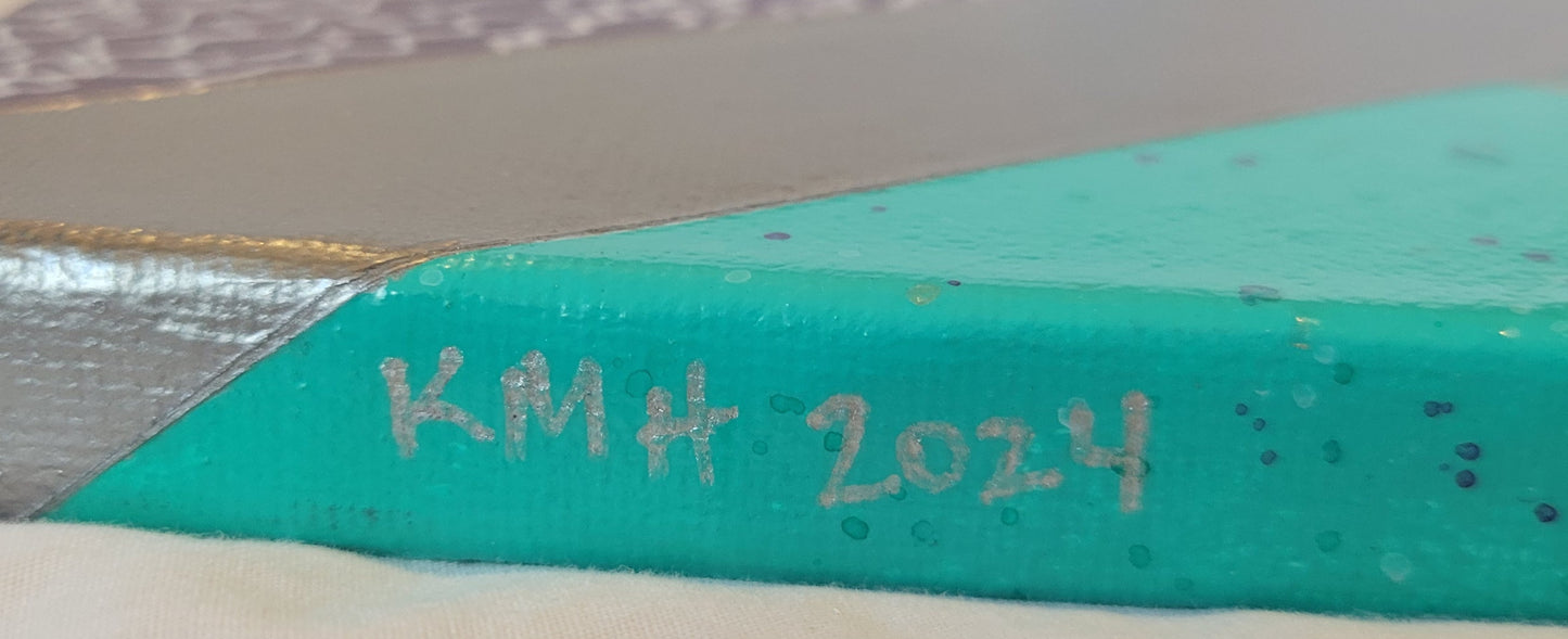 Close up edge of the aqua part of the canvas showing the artist's initals "KMH" and year completed "2024" in silver.