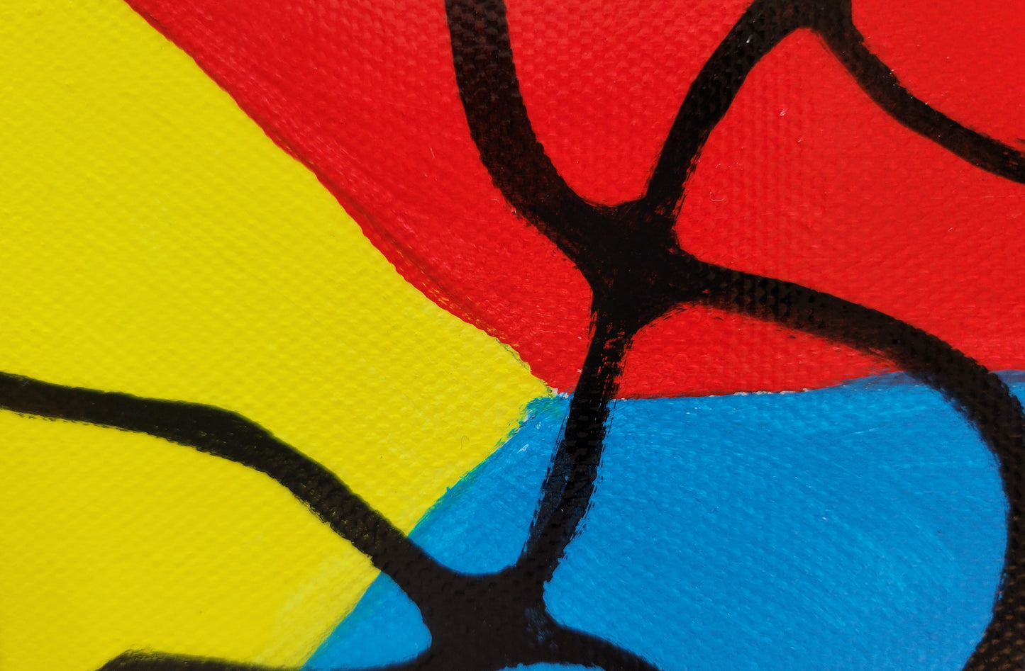Closeup detail showing the triangular intersection of the yellow, red, and blue, with several black lines intersecting nearby