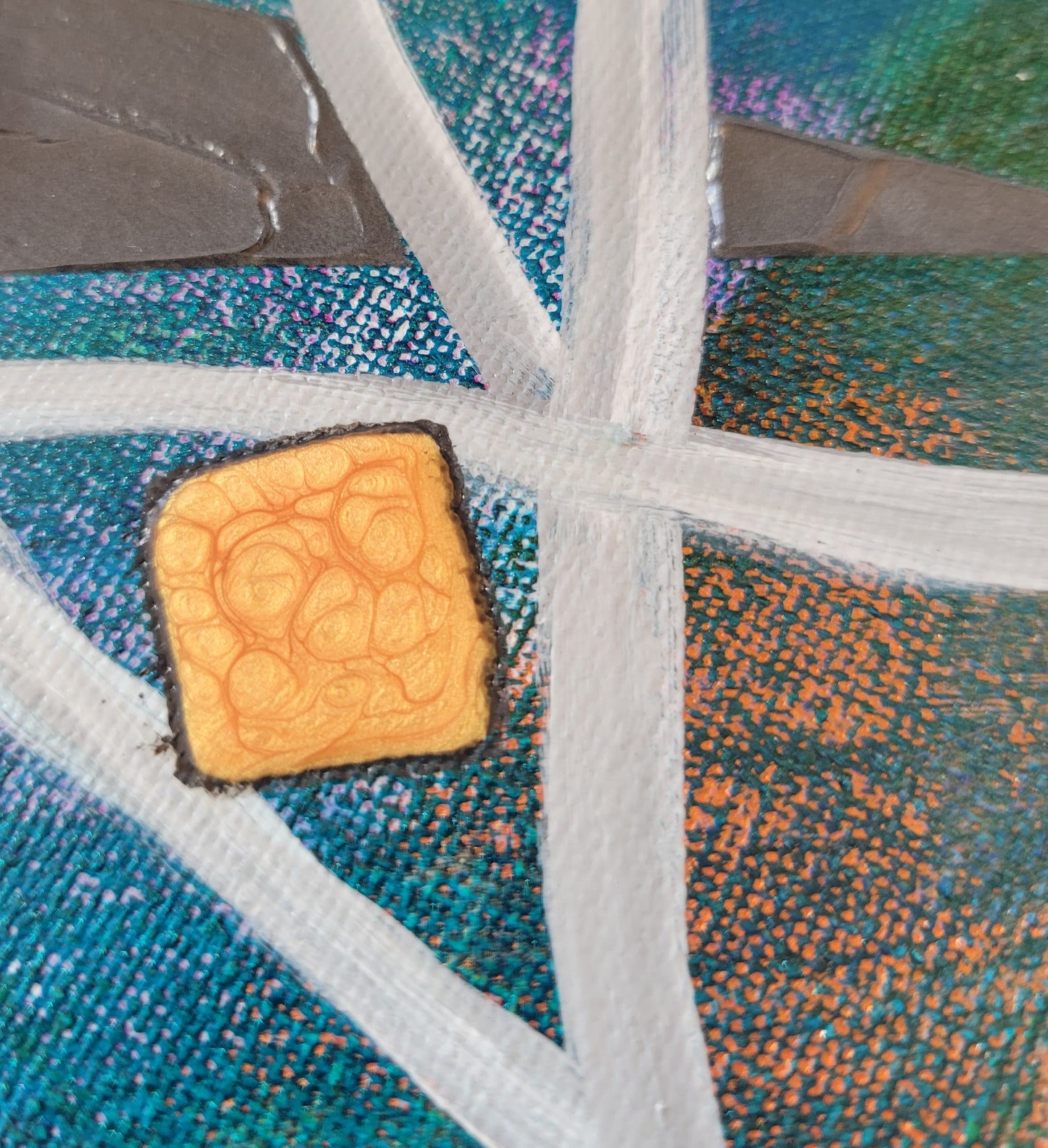 A close-up showing the blending of the teal into the orange and green as well as the subtle fondant-like texture of the gray triangular wedge. An orange square of alkyd oil is outlined in black.