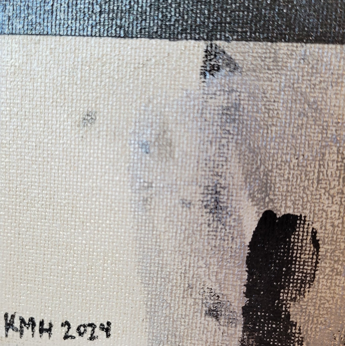 Close-up of the lower left corner of the canvas, showing some overlapping handprints but also "KMH 2024" written in black.
