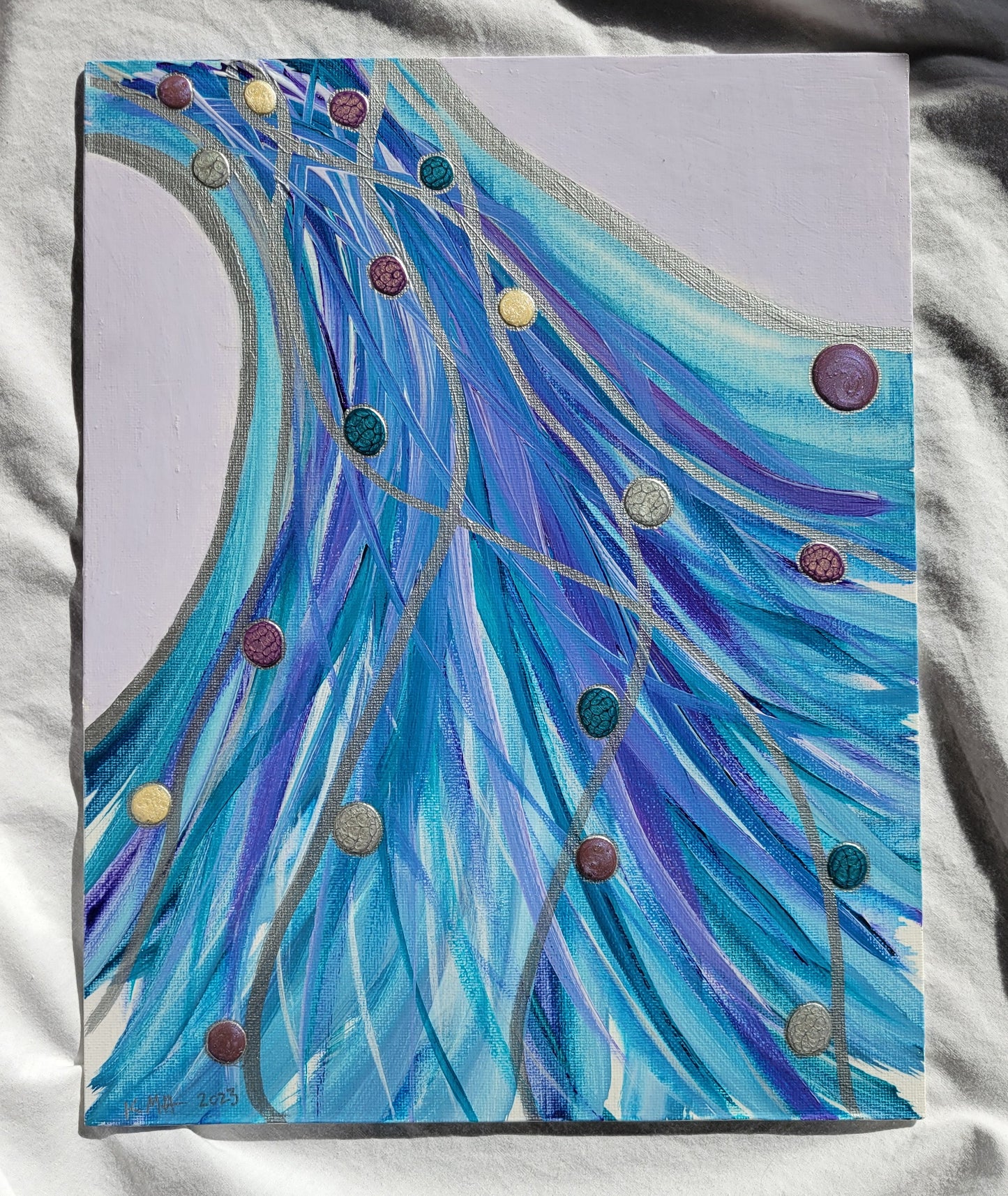 The unframed canvas panel in bright sunlight, showing the vibrant colors and metallic sheen of the silver lines.