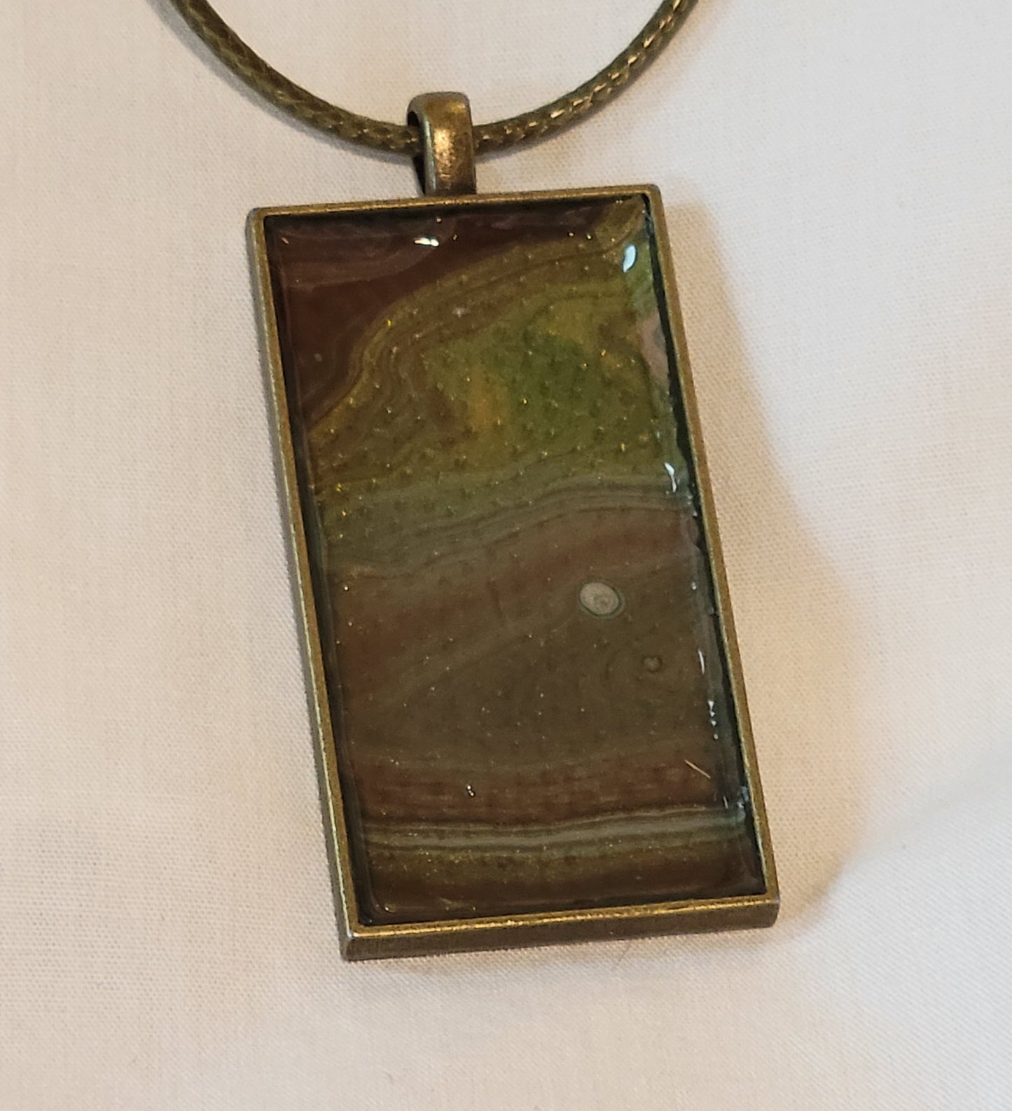 The banding pattern of the colors of the pendant call to mind looking down into the Grand Canyon from Moran Point.