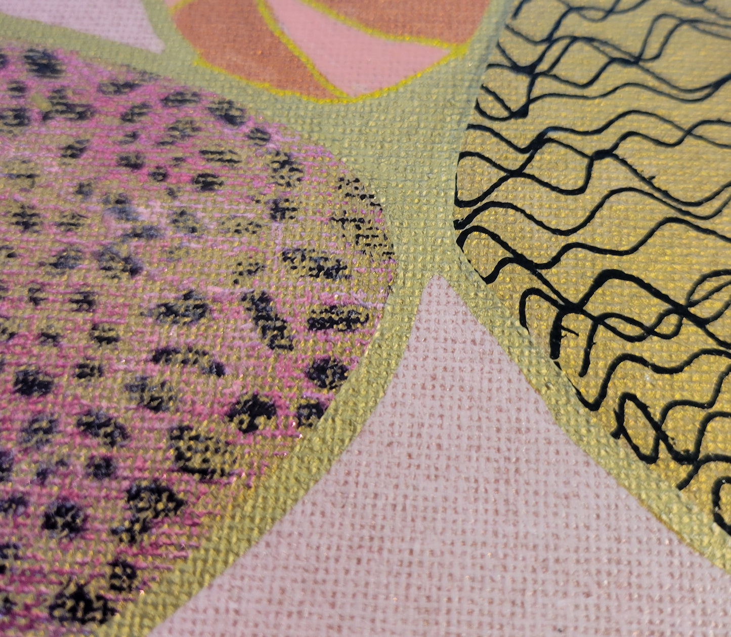 Close-up of the pink leopard print foil on a gold background. A section of gold with thin black squiggly lines can be seen. A portion of a copper, pink, and gold ball is nestled between the two sections. The distressed pink with gold flecks background can be seen better.