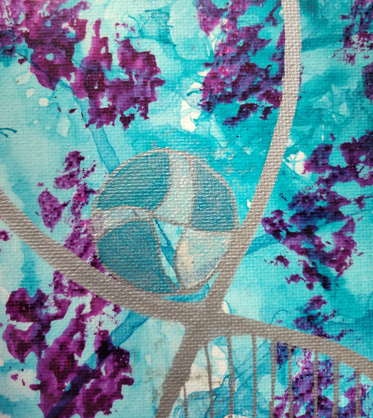 Closeup detail highlighting the blue ink spills overlapping and purple splotches. Over it all is an intersection of silver lines cradling a turquoise and pearl sphere.