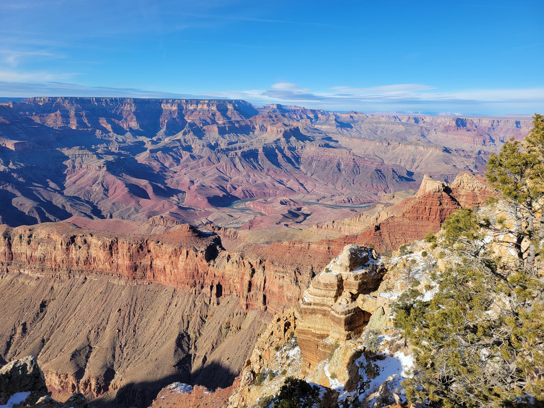 Grand Canyon from a Desert View Drive lookout point on a sunny winter day. The Colorado River can be seen weaving through the base of the Canyon.