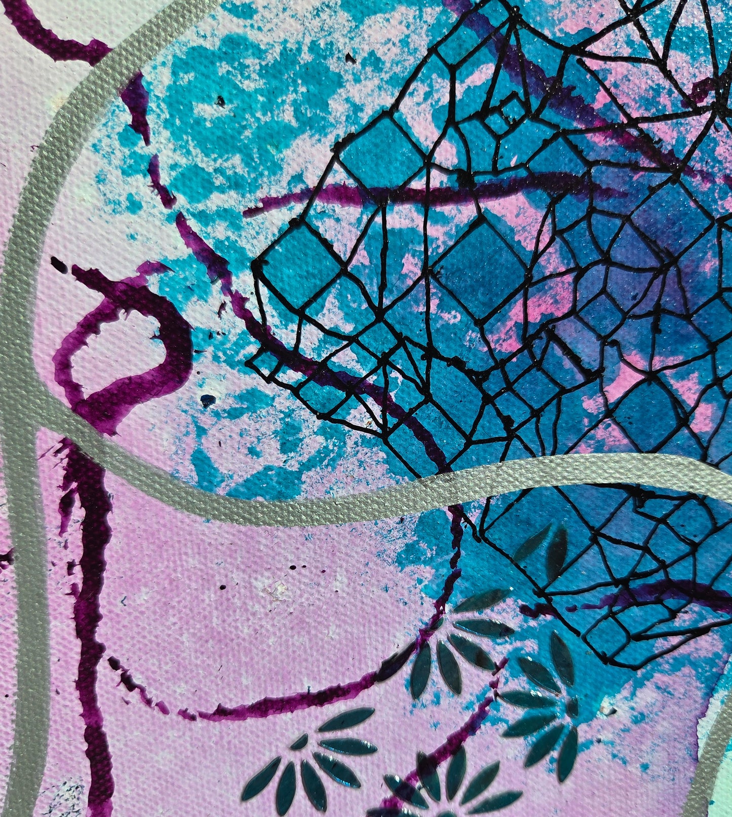 Close-up detail of the geometric design stencil work in black over teal ink splotches as purple and silver lines weave around and over it and teal gel daisies intrude.