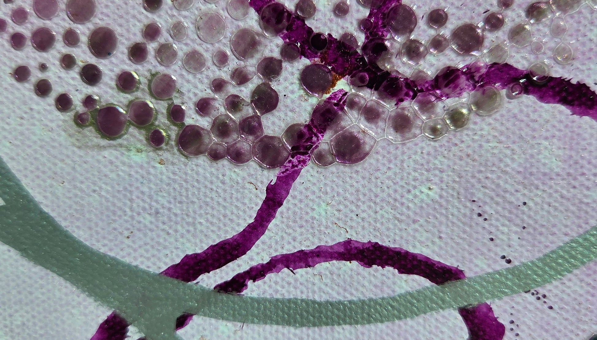 Close-up detail of the moon stencil, showing the silvery purple gel dots that resemble craters. Purple and silver lines weave under and over the design.