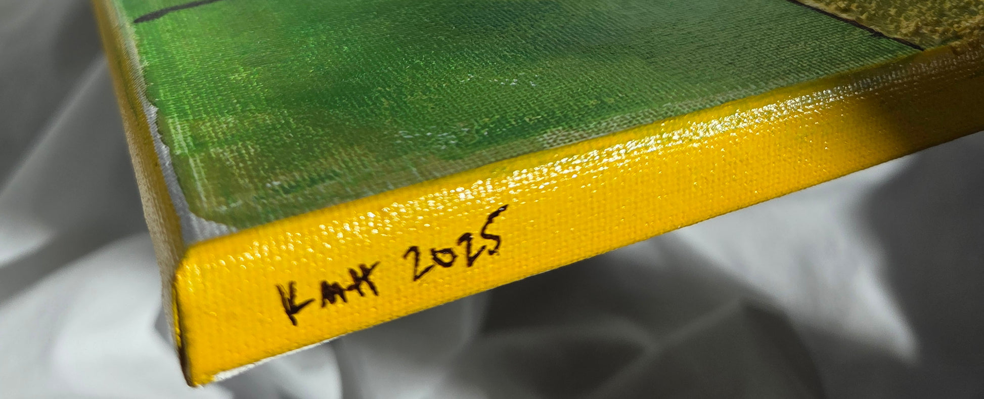 Close-up detail of the artist's initials and date of completion in brown on the yellow-painted edge of the canvas.