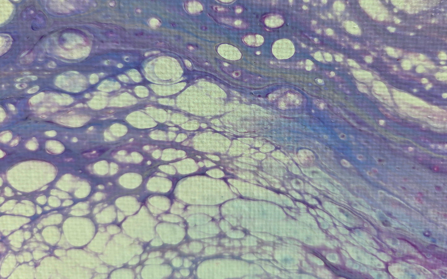 Close-p detail of more purple lacing over beige with blue undertones.