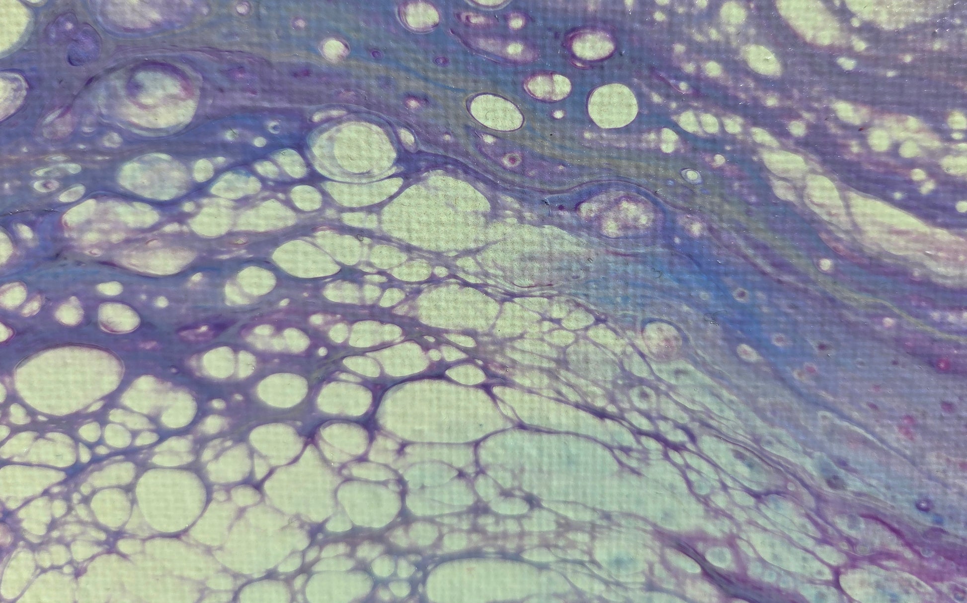 Close-p detail of more purple lacing over beige with blue undertones.