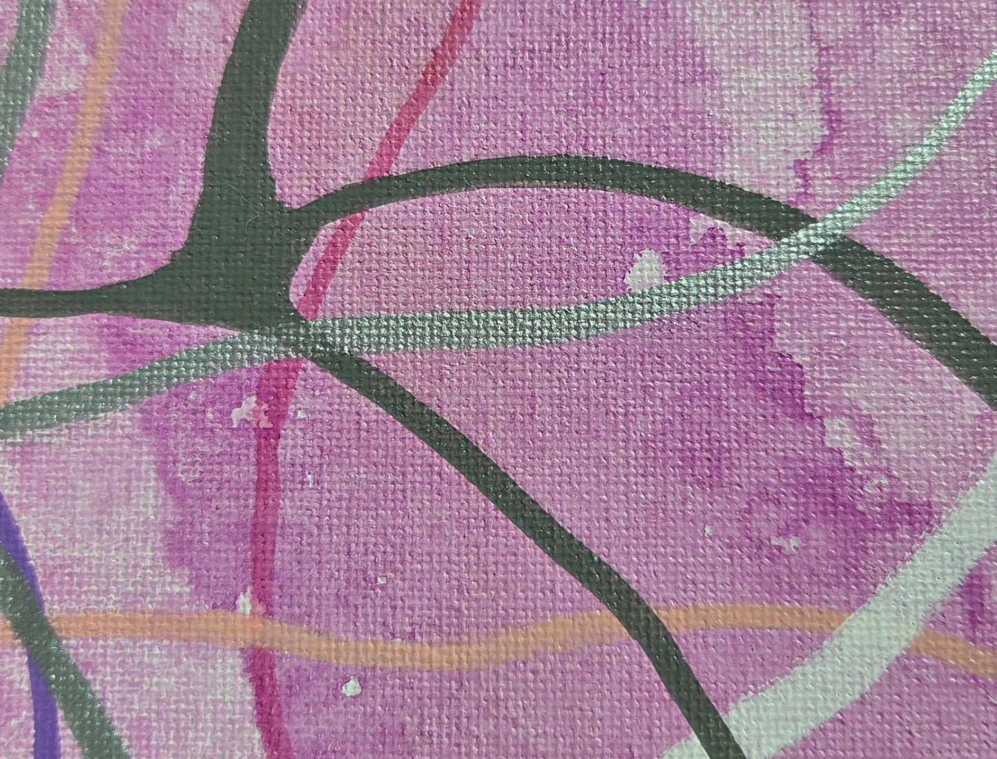 Close-up detail of the variegated fuchsia background of spilled ink. The overlapping of pink, gray, silver, and white lines is clearer.