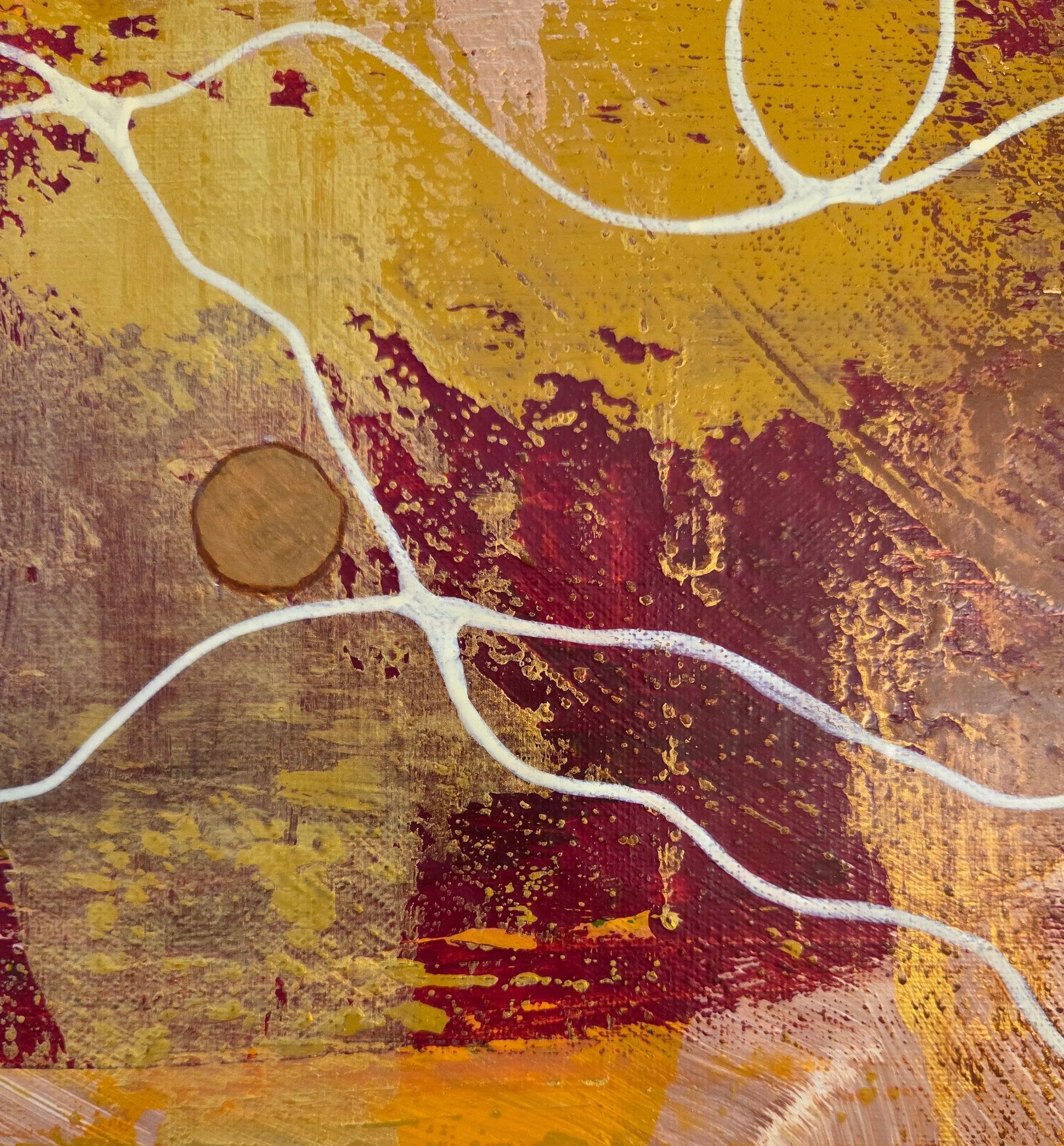 Close-up detail of a portion of red, yellow, and copper paint scraping over each other with the beige thread looping and weaving over it and copper button nestled in place.